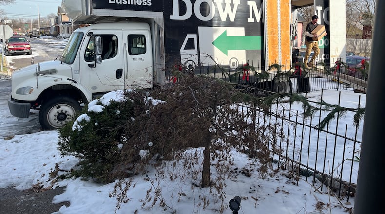 Employees with a moving company carry boxed items into a home in the South Park neighborhood in Dayton. CORNELIUS FROLIK / STAFF
