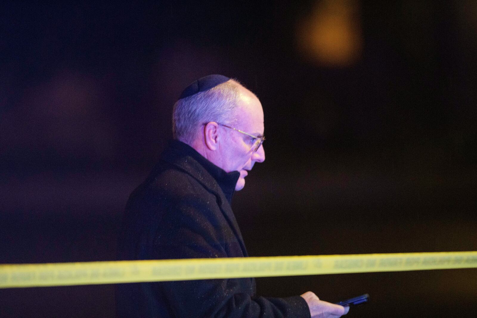 A man walks from the scene as law enforcement work the area after two staff members of the Israeli Embassy in Washington were shot and killed outside the Capital Jewish Museum, Thursday, May 22, 2025, in Washington.(AP Photo/Rod Lamkey, Jr.)