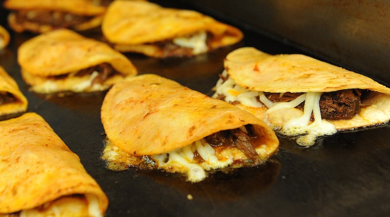 Taco Street Co. Birria Tacos cooking on the grill. MARSHALL GORBY\STAFF