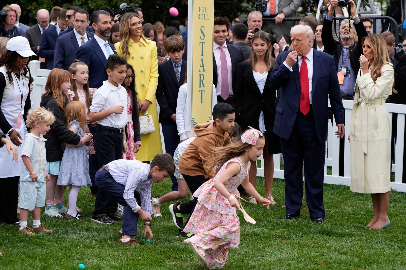 President Donald Trump and first lady Melania Trump blow whistles during the White House Easter Egg Roll on the South Lawn of the White House, Monday, April 21, 2025, in Washington. (AP Photo/Alex Brandon)