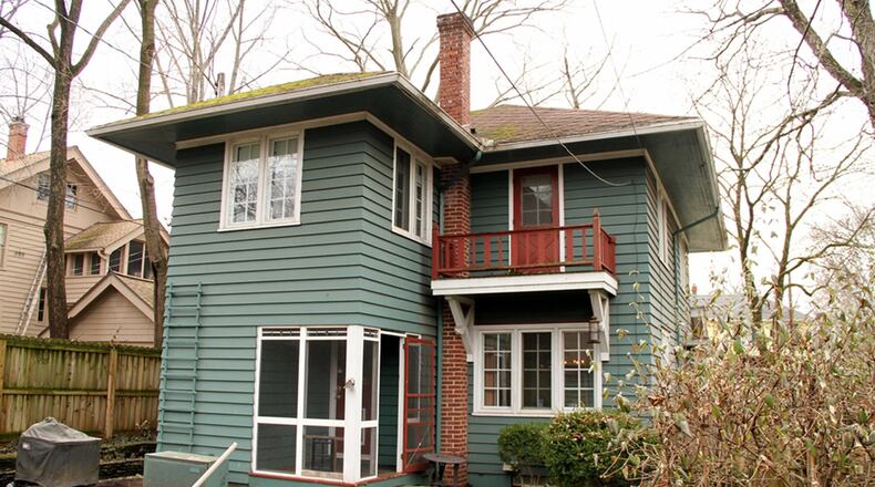 A screen-enclosed porch is off the updated kitchen. The porch opens out to a courtyard back yard with a brick patio, tiered gardens and surrounded by a wooden fence.