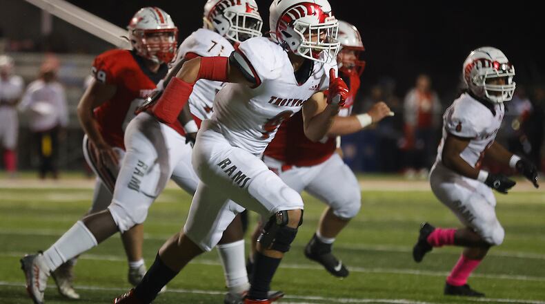 Trotwood's Issiah Evans moves in to tackle a Tipp ball carrier during Friday's playoff game. BILL LACKEY/STAFF