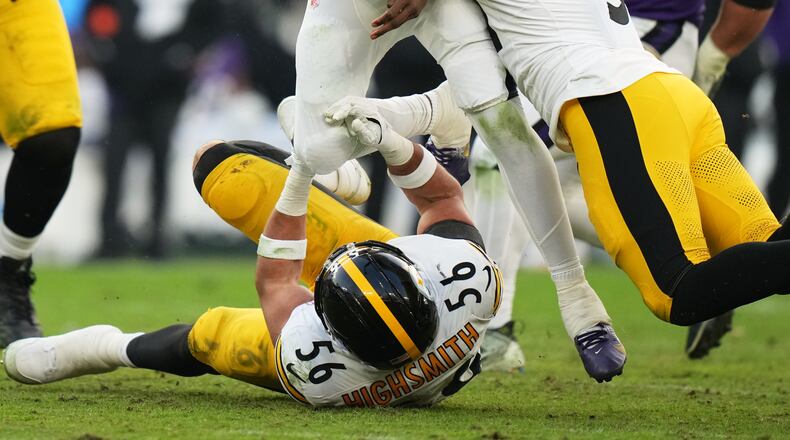 Pittsburgh Steelers linebacker Alex Highsmith (56) and linebacker Nick Herbig (51) tackle Baltimore Ravens quarterback Lamar Jackson (8) during the second half of an NFL football game, Sunday, Dec. 7, 2025, in Baltimore. (AP Photo/Stephanie Scarbrough)