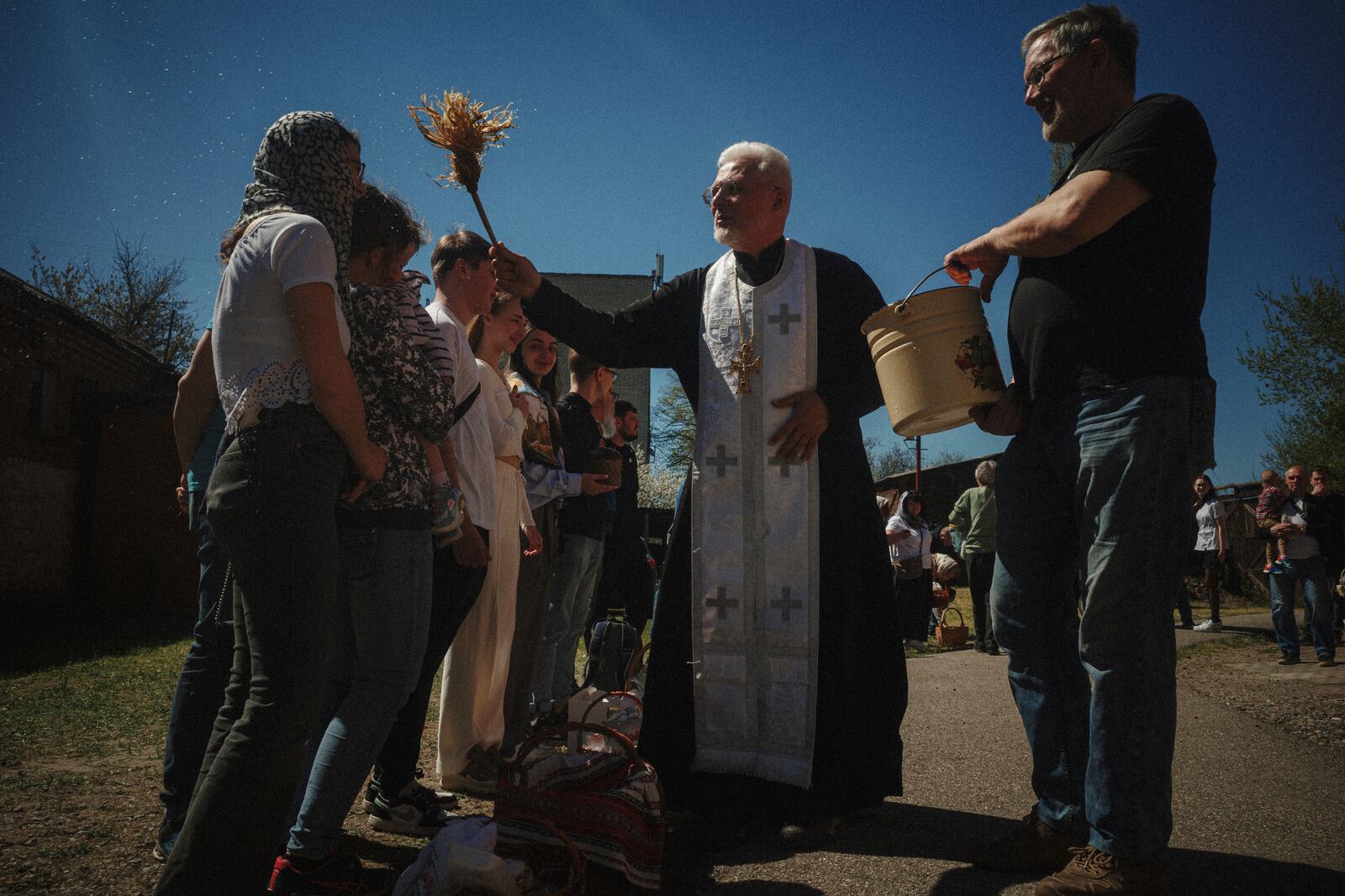 Father Henadii blesses Easter baskets during celebration of Orthodox Easter at St. John Theologian Church of the Orthodox Church of Ukraine in Kharkiv, Ukraine, on Sunday, April 20, 2025. (AP Photo/George Ivanchenko)