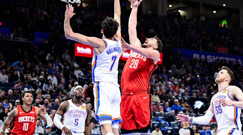 Houston Rockets center Alperen Sengun (28) shoots against Oklahoma City Thunder center/forward Chet Holmgren (7) during the second half of an NBA basketball game Saturday, Feb. 7, 2026, in Oklahoma City. (AP Photo/Gerald Leong)