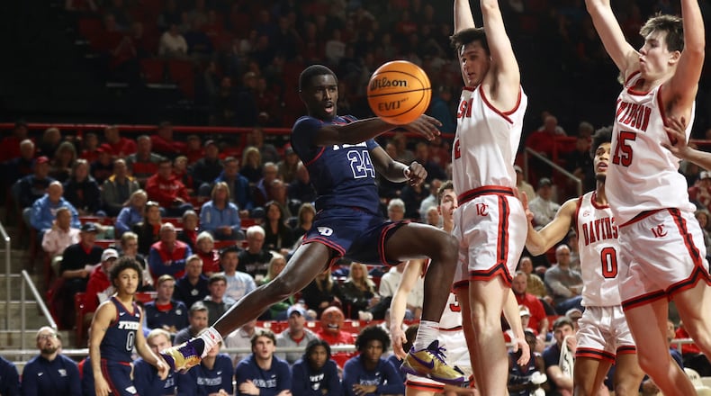 Dayton's Kobe Elvis makes a pass against Davidson on Wednesday, Jan. 3, 2024, at at Belk Arena in Davidson, N.C. David Jablonski/Staff