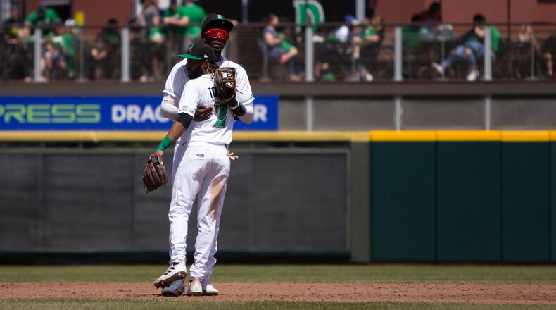 Before the start of each inning, Dragons second baseman Jose Torres (2) and shortstop Elly De La Cruz share a hug. They have become best friends since becoming teammates last summer in Daytona. Jeff Gilbert/CONTRIBUTED