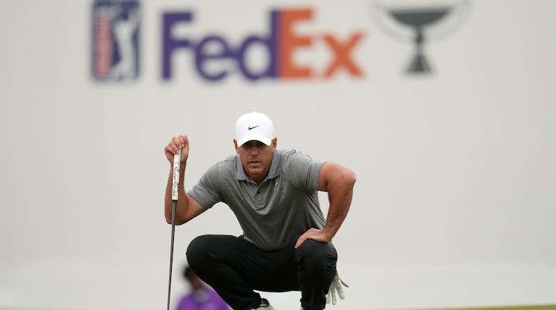 Brooks Koepka lines up a putt at the 16th green during the first round of the Phoenix Open golf tournament at the TPC Scottsdale Stadium Course Thursday, Feb. 5, 2026, in Scottsdale, Ariz. (AP Photo/Ross D. Franklin)