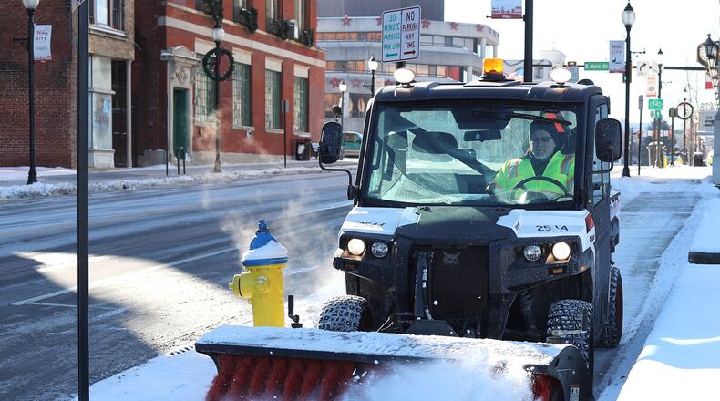 Snow removal crews, like this one in Springfield, have largely done their jobs, but cold temperatures could lead to more school closings. BILL LACKEY/STAFF