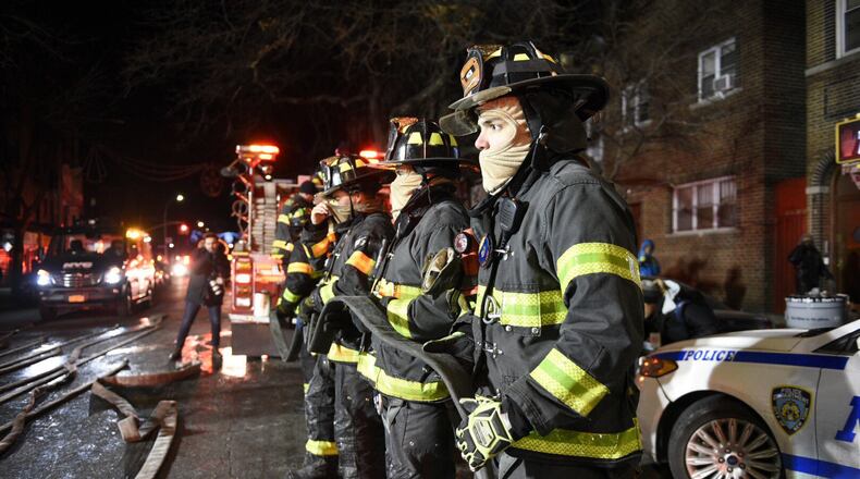 Firefighters at the scene of a deadly fire on in New York last December. A bill that passed the U.S. Senate last week would create a voluntary database of firefighters who contract cancer. The House approved a similar version of the bill last year. (David Dee Delgado/The New York Times)