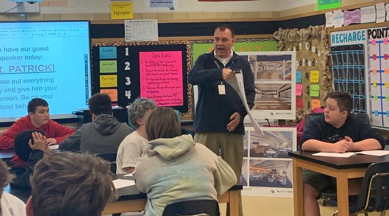 Jeff Patrick, director of business affairs and construction project manager, Fairborn City Schools, works with students in the Baker Middle School Logic and Problem Solving class on the current construction project at Fairborn Primary School. The class worked on devising the details of classrooms, hallways, cafeterias and more. Patrick presented information so that students could work in groups on their designated areas. Photo by Pam Gayheart