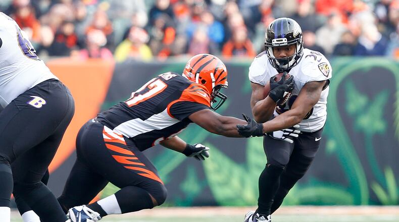 CINCINNATI, OH - JANUARY 1: Kenneth Dixon #30 of the Baltimore Ravens breaks an attempted tackle by Geno Atkins #97 of the Cincinnati Bengals during the third quarter at Paul Brown Stadium on January 1, 2017 in Cincinnati, Ohio. (Photo by Michael Hickey/Getty Images)