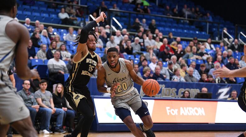 Akron’s Xeyrius Williams drives against Western Michigan’s Brandon Johnson during a game earlier this season. University of Akron photo