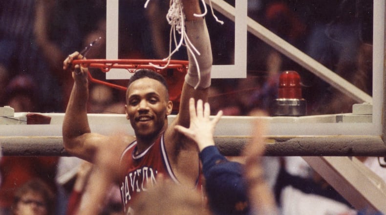 Dayton's Negele Knight cuts down the net after a victory against Xavier in the Midwestern Collegiate Conference tournament championship game in 1990 at UD Arena. Photo courtesy of UD