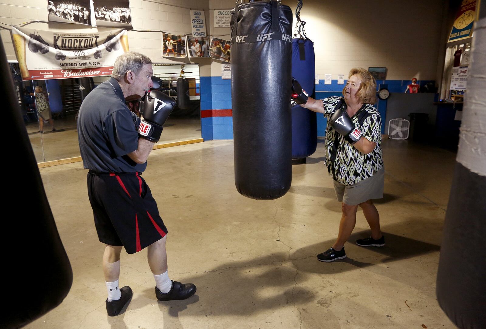 Pete Segi of Vandalia and his wife Stephanie work out together at Drake’s Downtown Gym in Dayton. Segi has Parkinson’s disease and boxing sessions help with balance, gait and other activities in daily life. LISA POWELL / STAFF