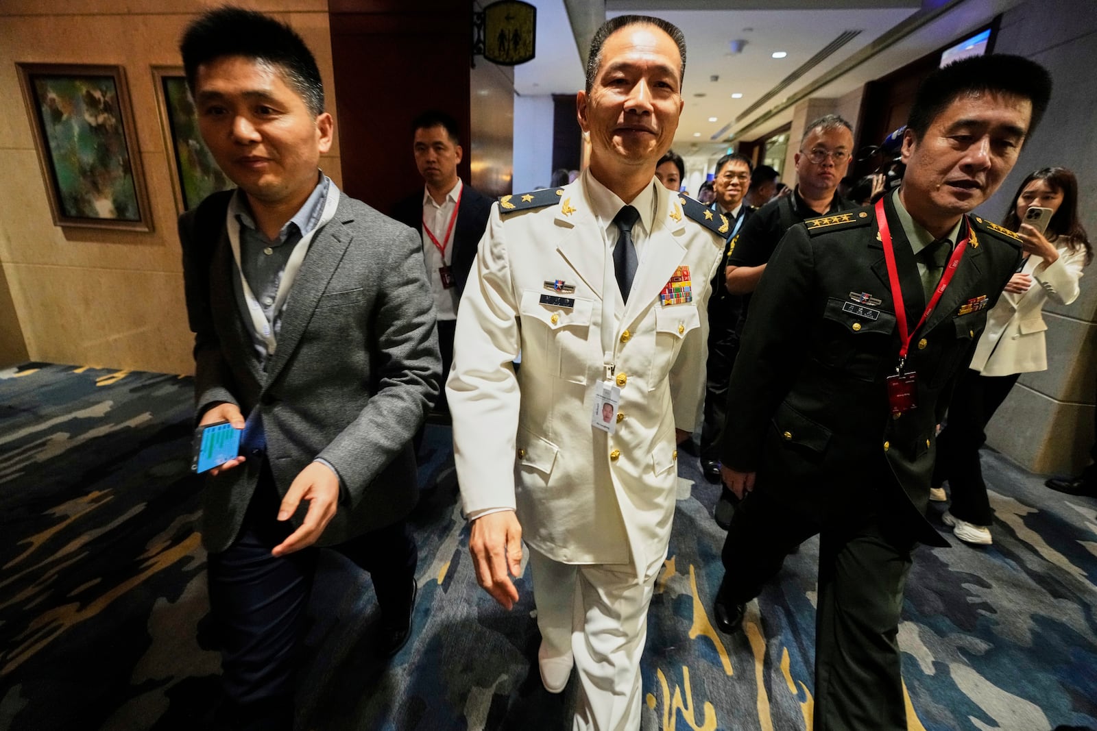Major General Hu Gangfeng, Vice President, National Defense University, People's Liberation Army, China, leaves after a panel discussion during the 22nd Shangri-La Dialogue summit in Singapore, Saturday, May 31, 2025. (AP Photo/Anupam Nath)