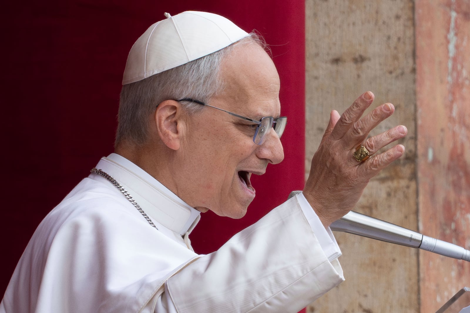 Pope Leo XIV speaks from the central balcony of St. Peter's Basilica from where he delivered his first Sunday blessing since his election to the faithful gathered in St. Peter's Square for the traditional Regina Caeli prayer at noon, on Sunday, May 11, 2025. (AP Photo/Domenico Stinellis)