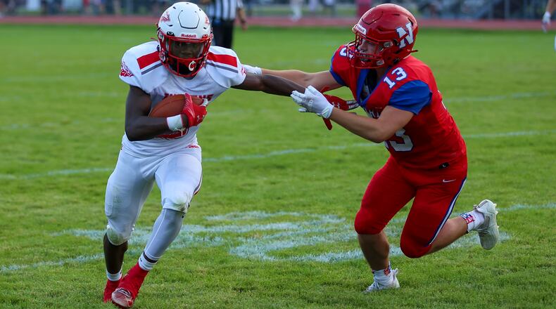 Stebbins High School's Rayvonn Harris-Belle runs past Northwestern's Nathan Arledge during their game on Thursday, Aug. 19, 2021, at Taylor Field in Springfield. CONTRIBUTED PHOTO BY MICHAEL COOPER