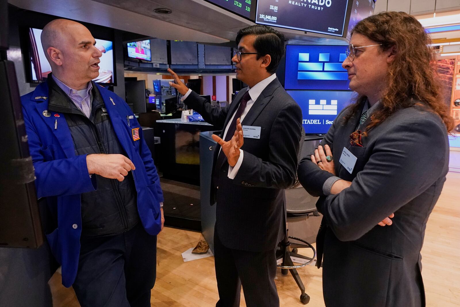 XPRIZE Carbon Removal winners from Mati Carbon, Founder & CEO Shantanu Agarwal, center, and Chief Science Officer Jake Jordan, right, talk with Specialist Philip Finale during their visit to the trading floor of the New York Stock Exchange, Tuesday, April 22, 2025. (AP Photo/Richard Drew)
