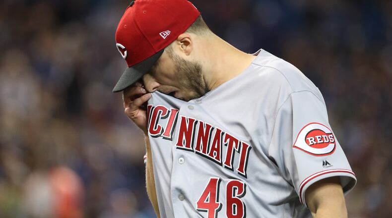 TORONTO, ON - MAY 31: Tim Adleman #46 of the Cincinnati Reds walks to his dugout after retiring the side in the second inning during MLB game action against the Toronto Blue Jays at Rogers Centre on May 31, 2017 in Toronto, Canada. (Photo by Tom Szczerbowski/Getty Images)