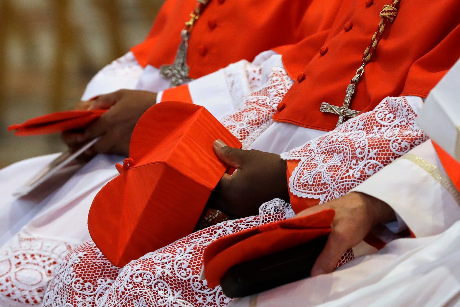FILE - Cardinals hold the red three-cornered biretta hats before a consistory inside the St. Peter's Basilica at the Vatican, Saturday, Nov. 19, 2016. (AP Photo/Gregorio Borgia, File)