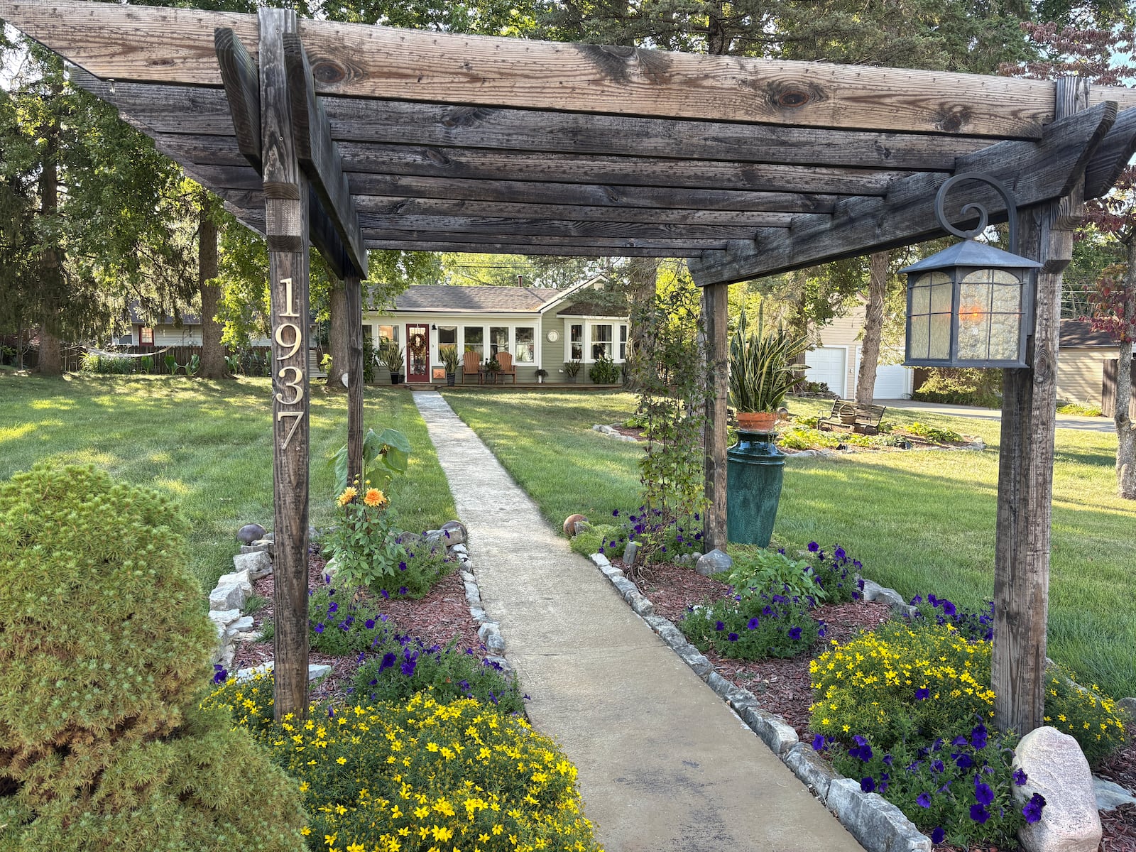 A trellis greets visitors at the walkway that leads to Bill Trent's Courtland Avenue house in Kettering, which received new siding, windows, gutters and downspouts, roof and HVAC system as part of free and deferred homeowner programs. JEN BALDUF/STAFF