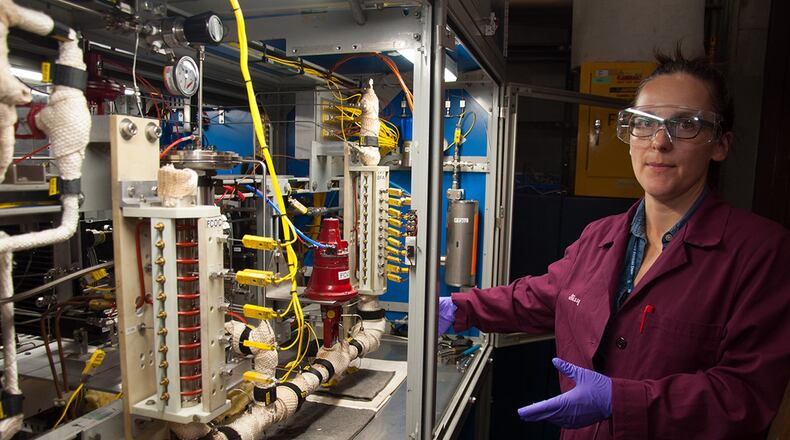 Milissa Griesenbrock, Air Force Research Laboratory Fuels and Energy Branch co-lead for High Impact Technology 1 - Fuel Science and research chemist, gives a tour of a fuel system simulator. The FSS simulates time and temperature heat loads along the flow pathway of jet fuel in order to investigate impacts of different fuel chemistries on real and simulated hardware. (U.S. Air Force photos/John Harrington)