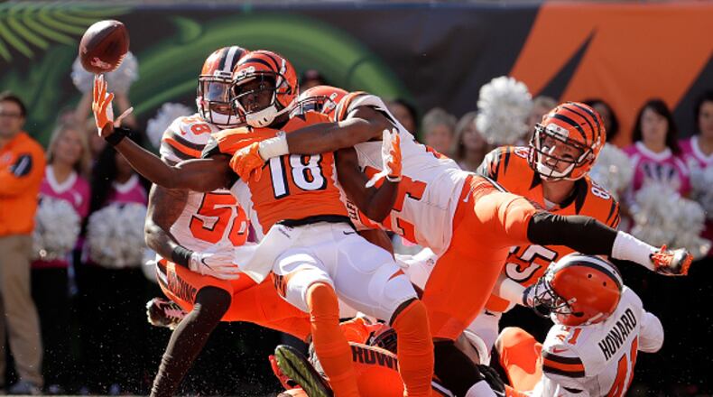 CINCINNATI, OH - OCTOBER 23: A.J. Green #18 of the Cincinnati Bengals catches a hail marry pass for a touchdown at the end of the second quarter of the game while being defended by Ibraheim Campbell #24 of the Cleveland Browns at Paul Brown Stadium on October 23, 2016 in Cincinnati, Ohio. (Photo by Andy Lyons/Getty Images)