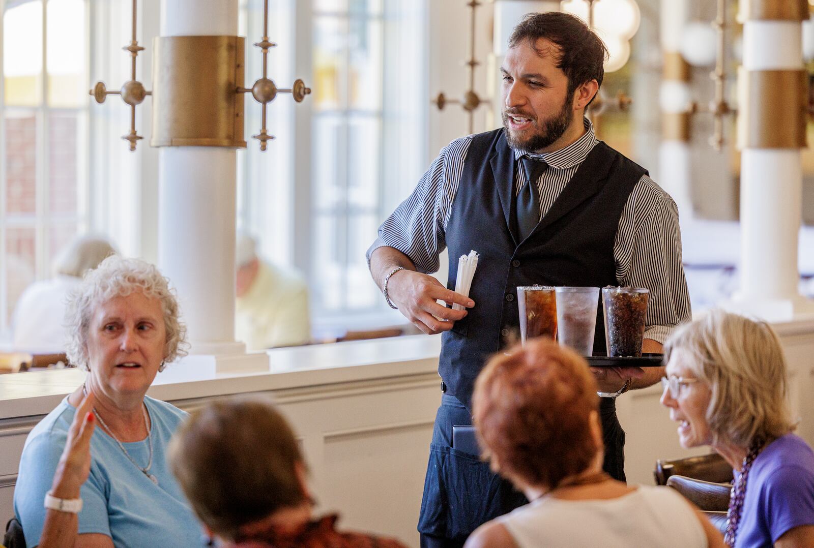 A server brings drinks to a table at Culp's Cafe in Carillon Historical Park on Tuesday, July 22. The recently passed federal spending bill includes a provision which allows employees in qualifying occupations to deduct tips to a maximum annual deduction of $25,000. BRYANT BILLING / STAFF