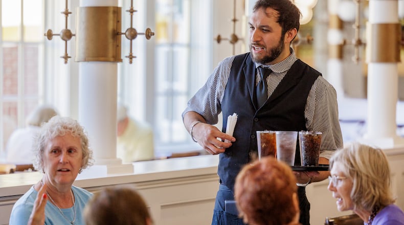 A server brings drinks to a table at Culp's Cafe in Carillon Historical Park on Tuesday, July 22. The recently passed federal spending bill includes a provision which allows employees in qualifying occupations to deduct tips to a maximum annual deduction of $25,000. BRYANT BILLING / STAFF
