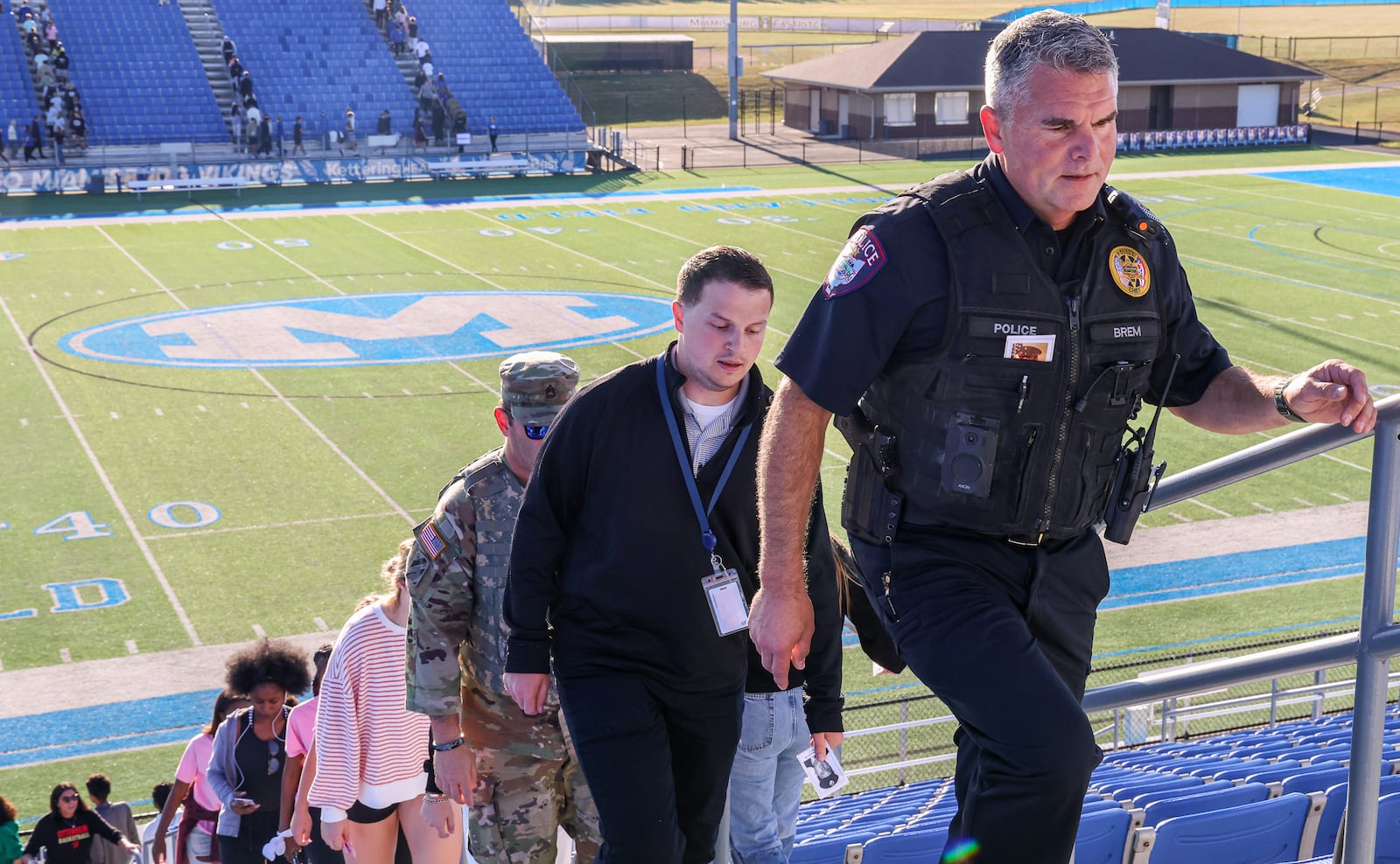 Miamisburg Police Chief Michael Brem leads Miamisburg High School students and staff up stairs at Holland Field on Monday, Sept. 8 during the school's fifth annual 9/11 Memorial Stair Climb. Students, staff, first responders and military service members climbed bleachers in honor of those who died on Sept. 11, each carrying a card with a victim’s name. BRYANT BILLING / STAFF
