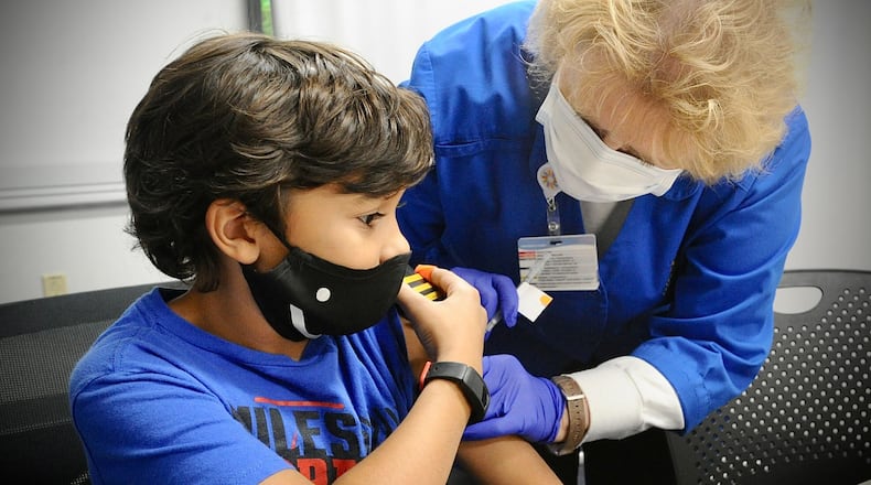 Roman Collier, age 10, receives his COVID-19 vaccine at Dayton Children's Monday, Nov. 8, 2021. Children under 5 years old will be able to receive COVID-19 vaccines starting Tuesday at Dayton Children’s Hospital. MARSHALL GORBY\STAFF