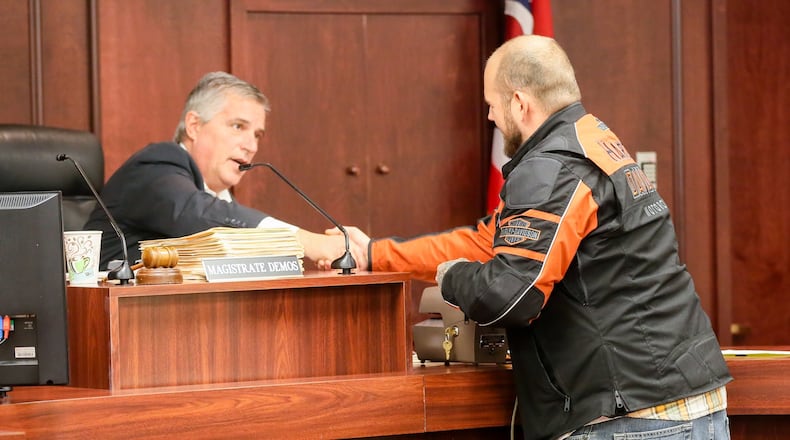 Magistrate Greg Demos congratulates Eric Carl of Franklin on his progress in Franklin Municipal Court's version of a drug diversion docket in 2016. Xenia Municipal Court was approved for an addiction recovery docket in 2023. GREG LYNCH / FILE PHOTO