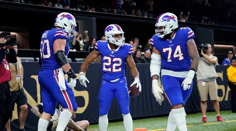 Buffalo Bills running back Matt Breida (22) celebrates his touchdown with guard Cody Ford (74) and center Mitch Morse (60) in the second half of an NFL football game against the New Orleans Saints in New Orleans, Thursday, Nov. 25, 2021. (AP Photo/Derick Hingle)