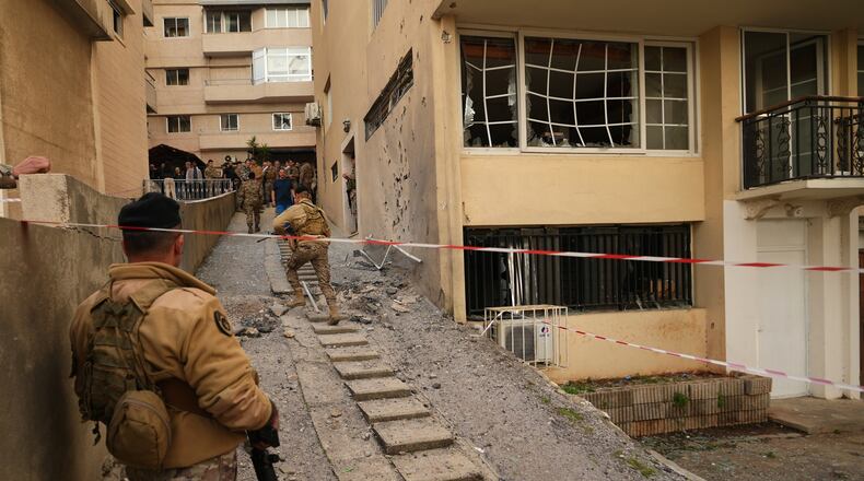 Lebanese army soldiers check the site where intercepted missiles fell in Sahel Alma, north of Beirut, Lebanon, Tuesday, March 24, 2026. (AP Photo/Hassan Ammar)