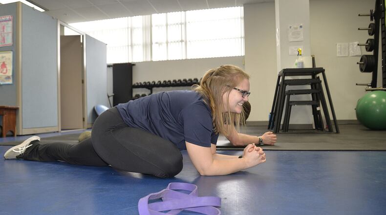 Hannah Kohne, a contractor at the 711th Human Performance Wing, Air Force Research Laboratory, Wright-Patterson Air Force Base, stretches as a part of the Function Bridge Fitness Study on Feb. 14th. The study is a 15-week program where participants have the oportunity to work with trainers to achieve their fitness goals. (U.S. Air Force photo/Airman 1st Class Emily Woodring)