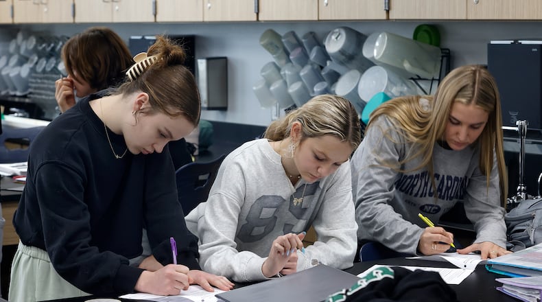 Students Carleigh Henson, Brenna Hensley and Jordan DeGroat work on making a parachute in William Heistand's science class Monday, Feb. 3 at the new Valley View high school. MARSHALL GORBY\STAFF