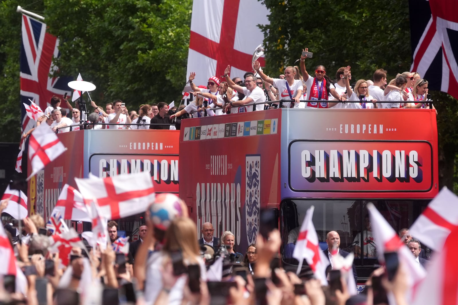 Buses carrying England players and staff make their way down the Mall during a Homecoming Victory Parade in London, Tuesday July 29, 2025, two days after England defended their European Championship crown as they beat Spain on penalties in the final of Euro 2025. (Adam Davy/PA via AP, Pool)