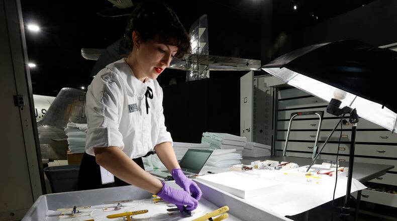 Conservator Sarah Gilcrease from the Collections Division at the National Museum of the U.S. Air Force inspects, catalogs and packs model aircraft from the Kettering Model Collection for shipping to the conservation firm ICA in Cleveland, Ohio. After the conservation process has been completed, the 624-piece model aircraft will be displayed in a new case in the museum's Kettering Hall in the spring of 2025. (U.S. Air Force photo by Ty Greenlees)