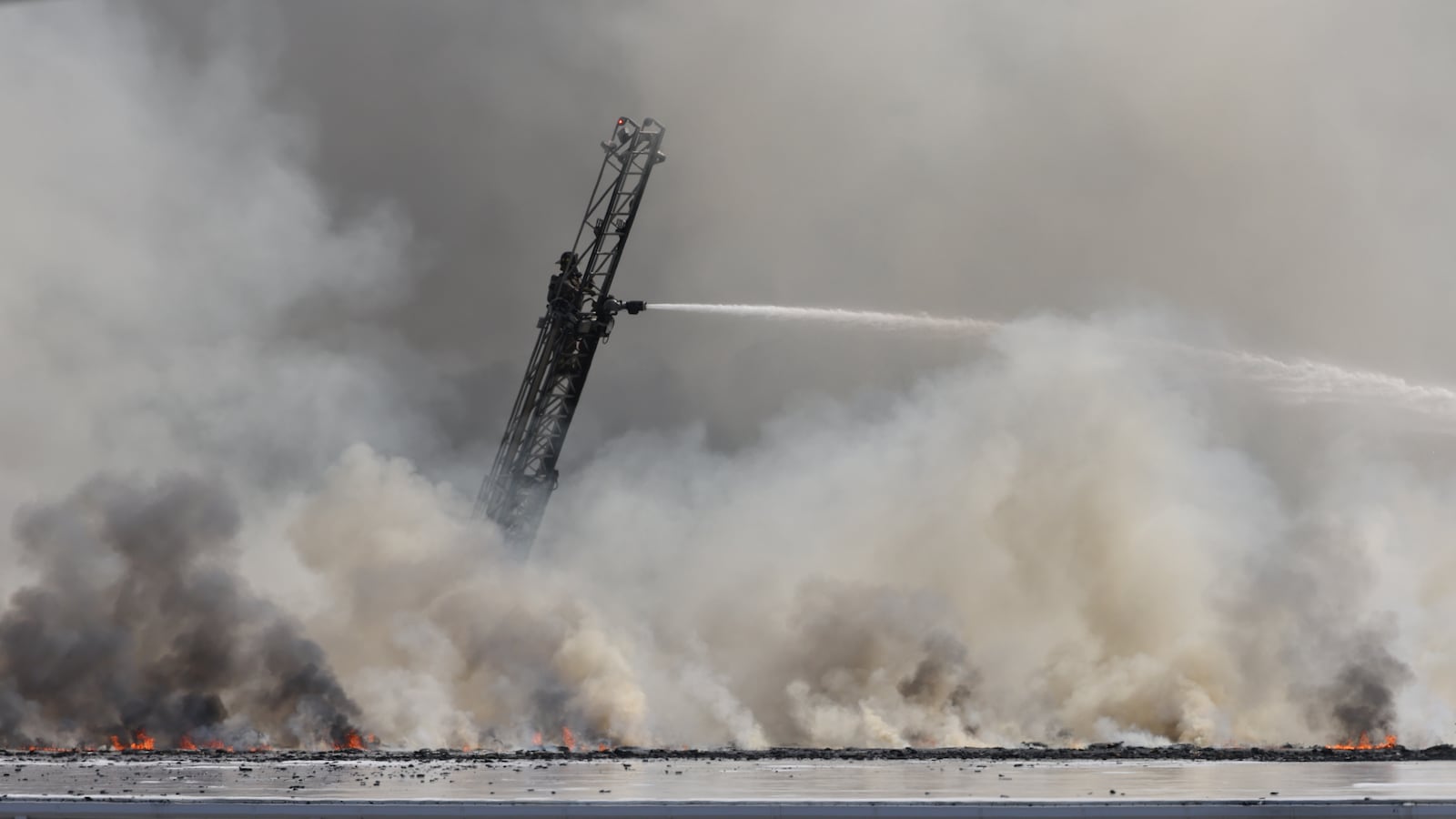 The fire at Fuyao Glass America rekindled shortly before noon on Tuesday, March 24. While firefighters have been working at the site since it first caught fire Sunday night, they had been focusing on hotspots before a large rekindling caused black smoke to rise that was visible for miles. The building that caught fire was Fuyao's coating facility, which was still in the finishing stages of construction. BRYANT BILLING / STAFF