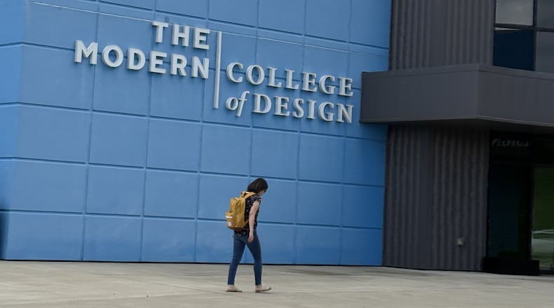 A student walks past the sign on The Modern College of Design building Friday, June 6, 2025, at the school in Kettering. JEN BALDUF/STAFF