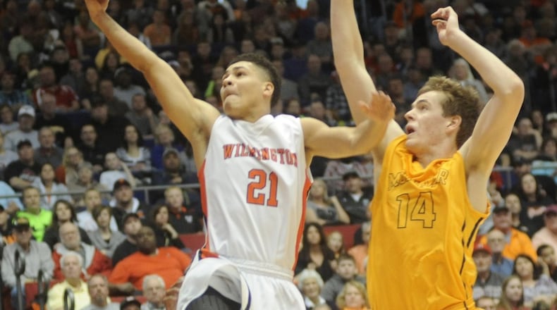 Wilmington’s Jaevin Cumberland avoids Moeller’s Riley Voss to score. Moeller upset Wilmington 46-43 in a boys high school basketball Division I district final at UD Arena on Friday, March 14, 2015. MARC PENDLETON / STAFF