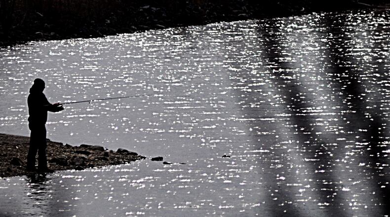 Warmer temperatures called fishing enthusiasts to the shimmering Eastwood Lake waters at Eastwood MetroPark last month. MARSHALL GORBY / STAFF