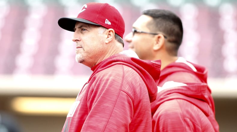 Reds manager Bryan Price watches the team warm up at Fifth Third Field on Saturday, April 1, 2017, in Dayton. David Jablonski/Staff