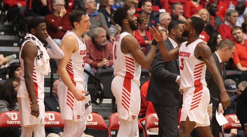 Dayton players celebrate in the final minute of a victory against Richmond on Sunday, Jan. 6, 2019, at UD Arena. David Jablonski/Staff