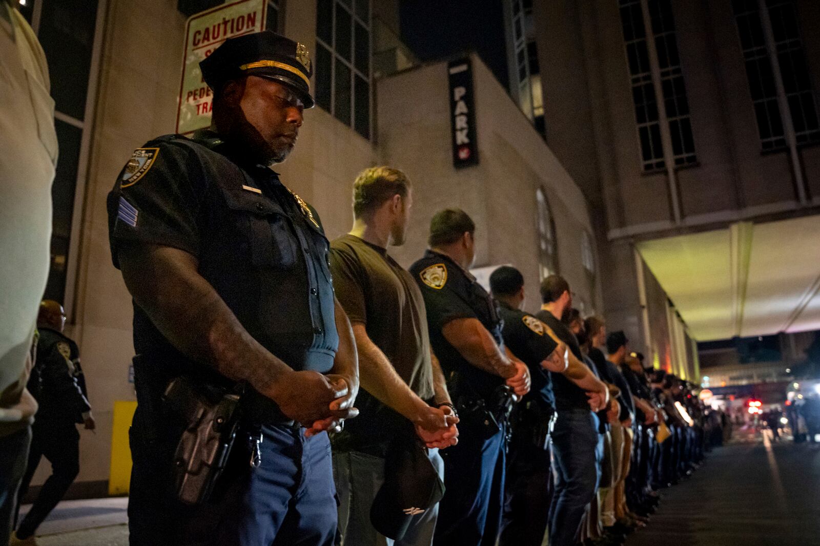 NYPD officers stand in line during the dignified transfer of Didarul Islam, who was shot and killed by a gunman Monday evening, out of NewYork-Presbyterian/Weill Cornell Medical Hospital to the medical examiner's office, early Tuesday, July 29, 2025, in New York. (AP Photo/Angelina Katsanis)