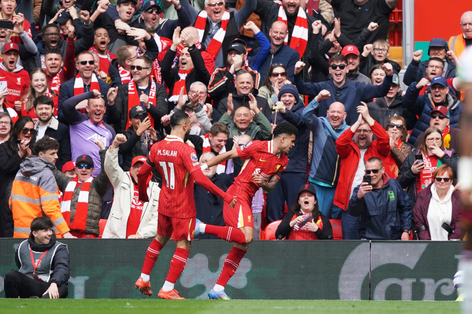 Liverpool's Luis Diaz, centre, celebrates after scoring his side's opening goal during the English Premier League soccer match between Liverpool and West Ham United at Anfield in Liverpool, Sunday, April 13, 2025. (AP Photo/Ian Hodgson)