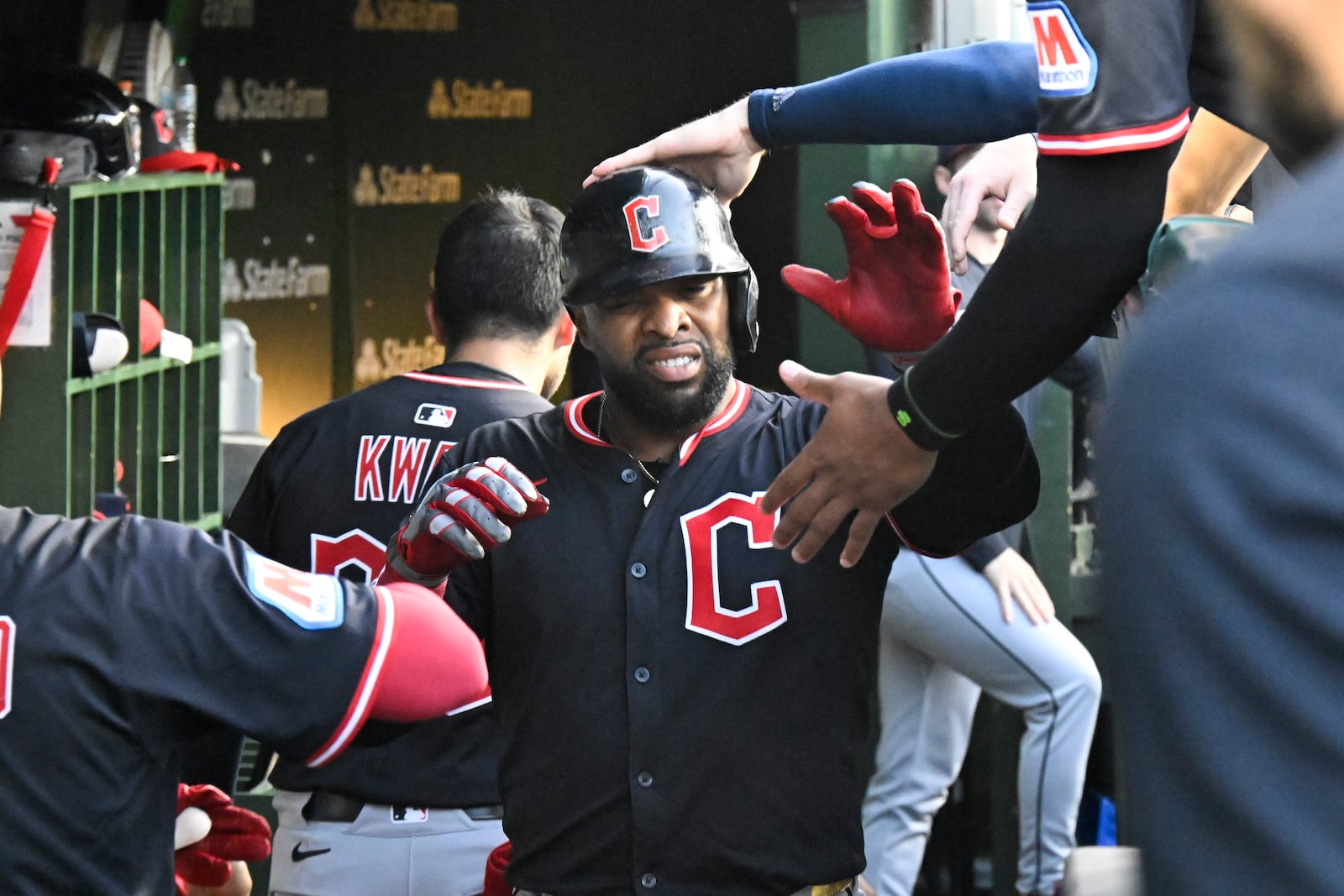 Cleveland Guardians' Carlos Santana celebrates in the dugout after scoring during the fourth inning of a baseball game against the Chicago Cubs, Tuesday, July 1, 2025, in Chicago. (AP Photo/Matt Marton)