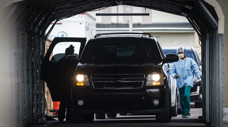 File - Long lines for COVID-19 testing at Dayton Children's Hospital wrapped around the parking lot on the northside of the complex in September 2021. Dayton Children's provided COVID testing for adults and children during the pandemic, as well as became a subcontractor for the Ohio Department of Health in processing COVID tests. JIM NOELKER/STAFF
