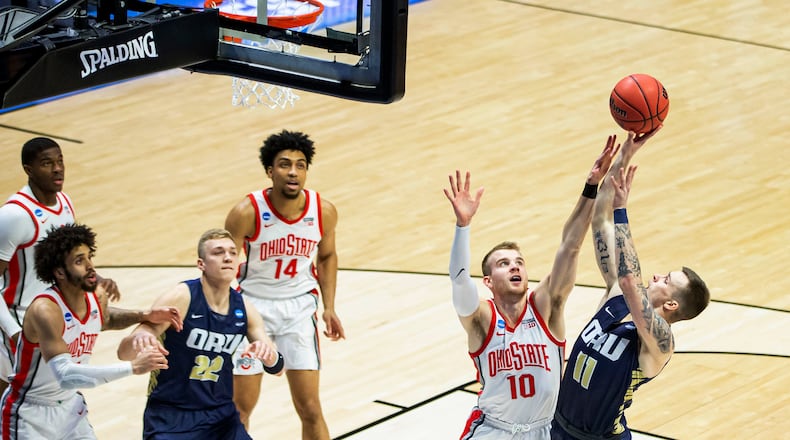 Oral Roberts' Carlos Jürgens (11) shoots over Ohio State's Justin Ahrens (10) during the first half of a First Round game in the NCAA men's college basketball tournament, Friday, March 19, 2021, at Mackey Arena in West Lafayette, Ind. (AP Photo/Robert Franklin)